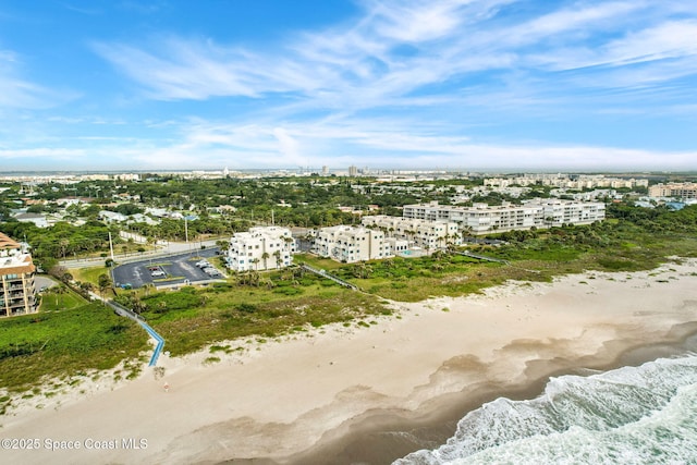 drone / aerial view with a beach view and a water view