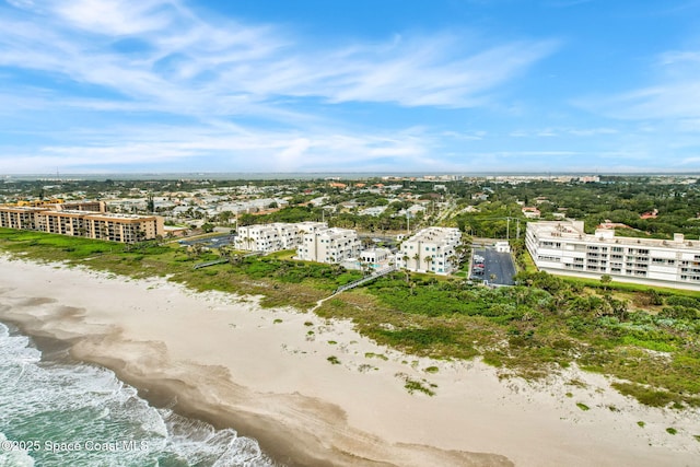 bird's eye view with a water view and a beach view