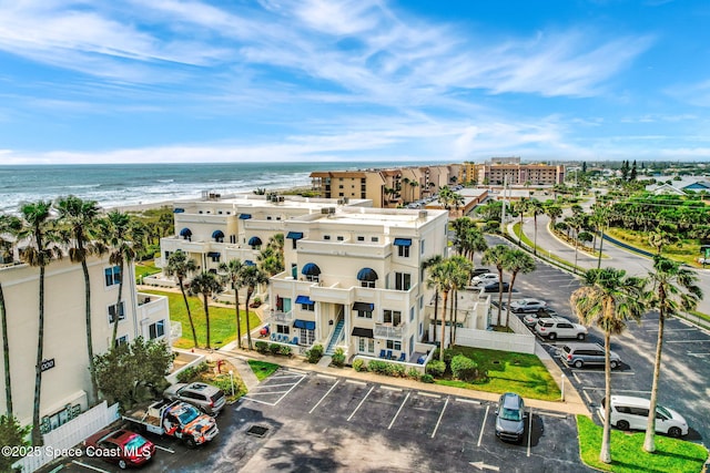 drone / aerial view with a beach view and a water view