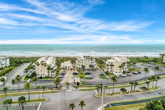 aerial view with a water view and a view of the beach