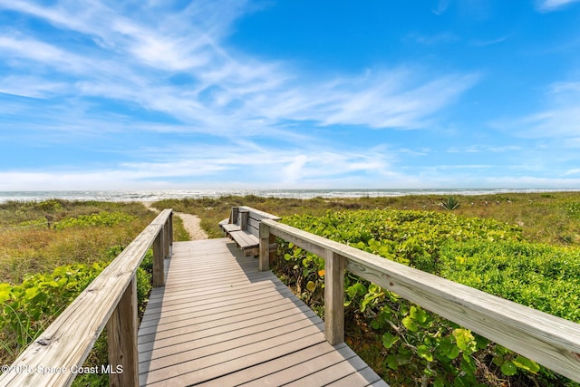 view of property's community featuring a water view and a view of the beach