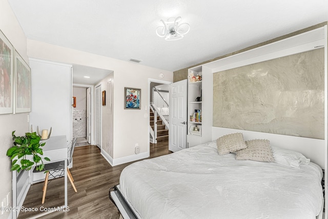 bedroom with dark wood-type flooring