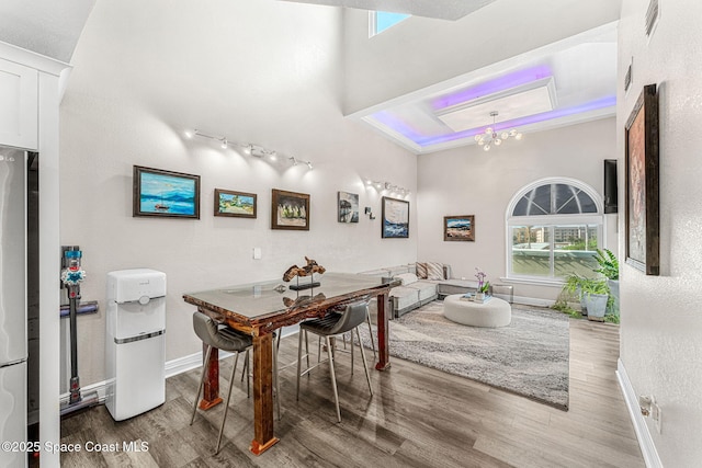 dining area with hardwood / wood-style flooring and a notable chandelier