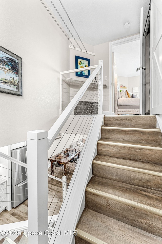 stairs with wood-type flooring