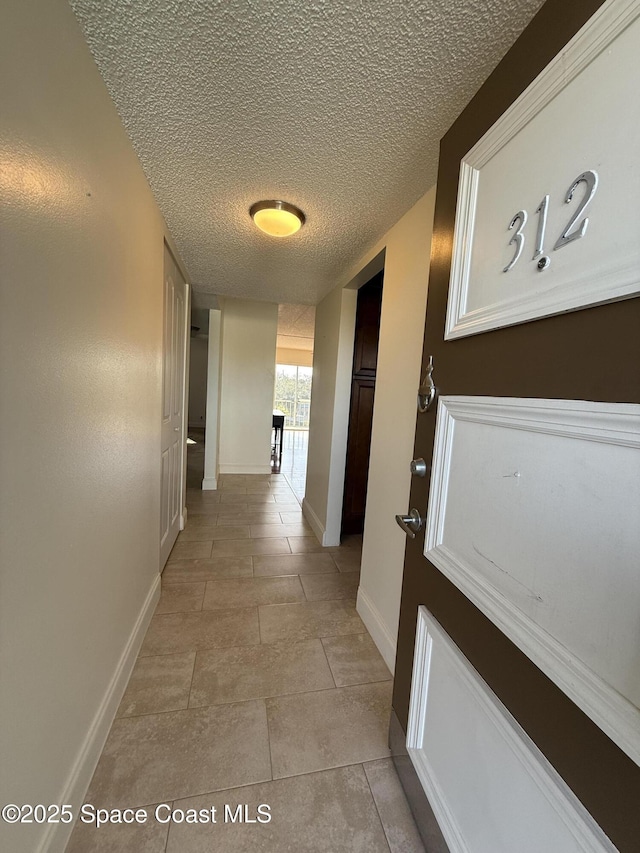 hall with a textured ceiling