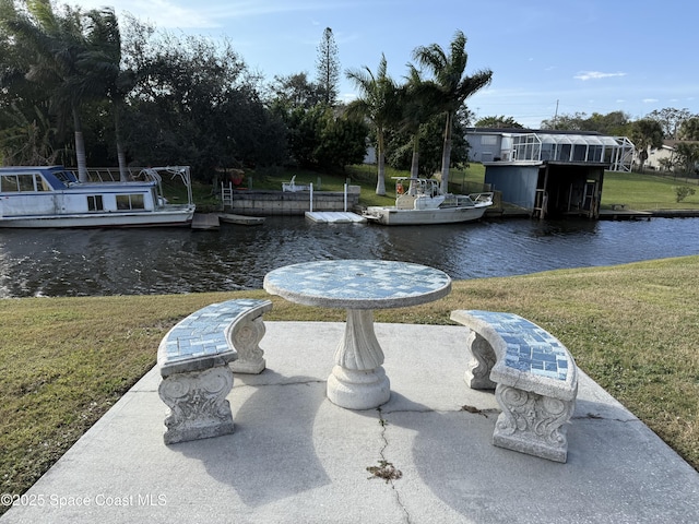 view of dock featuring a lawn