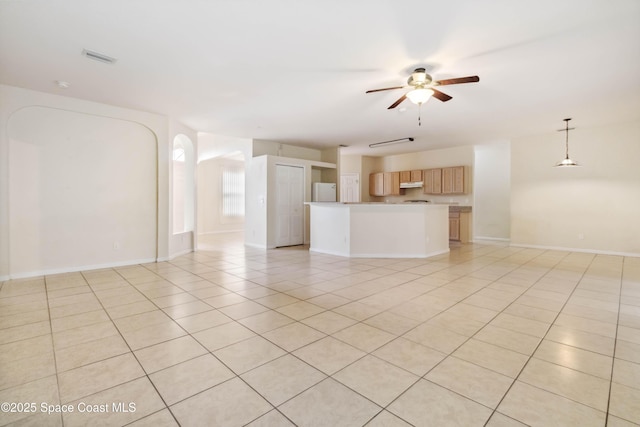 unfurnished living room with ceiling fan and light tile patterned floors