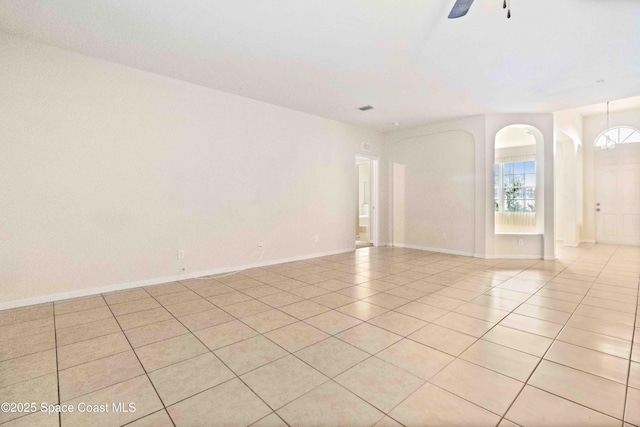 tiled empty room with ceiling fan