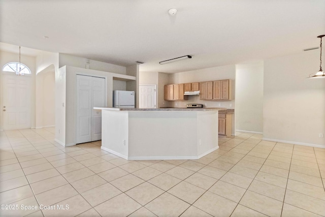 kitchen with decorative light fixtures, a center island, light tile patterned flooring, stainless steel range oven, and white refrigerator