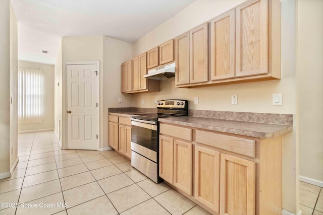 kitchen featuring stainless steel electric stove, light brown cabinets, and light tile patterned floors