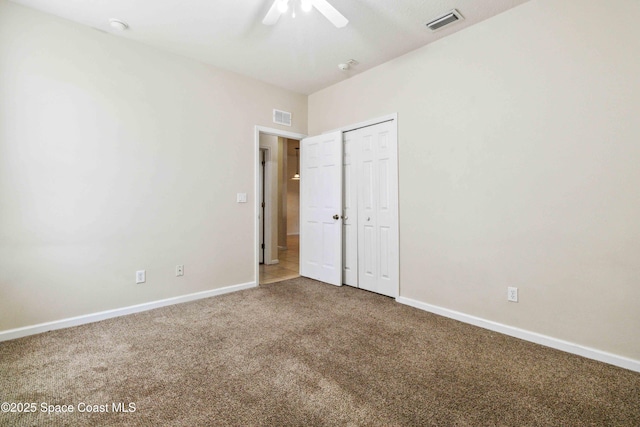 unfurnished bedroom featuring ceiling fan, carpet, and a closet