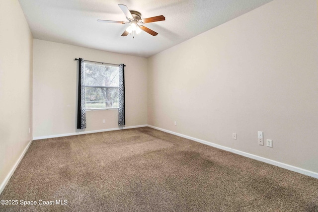 unfurnished room with ceiling fan and carpet flooring