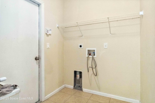 laundry area with washer hookup, electric dryer hookup, and light tile patterned flooring