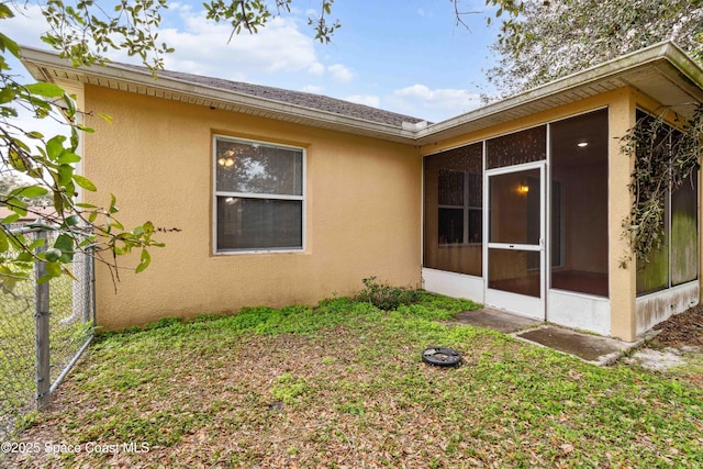 view of property exterior with a sunroom