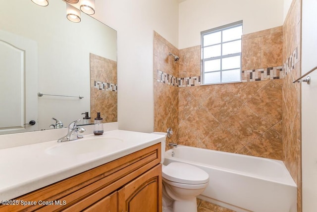 full bathroom featuring toilet, vanity, and tiled shower / bath combo