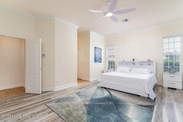 bedroom with ceiling fan, crown molding, and light wood-type flooring