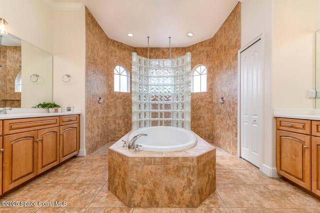 bathroom with independent shower and bath, tile walls, and vanity