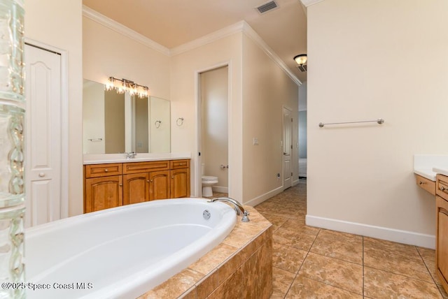 bathroom featuring tile patterned flooring, tiled tub, vanity, toilet, and ornamental molding