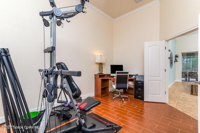 exercise area featuring crown molding