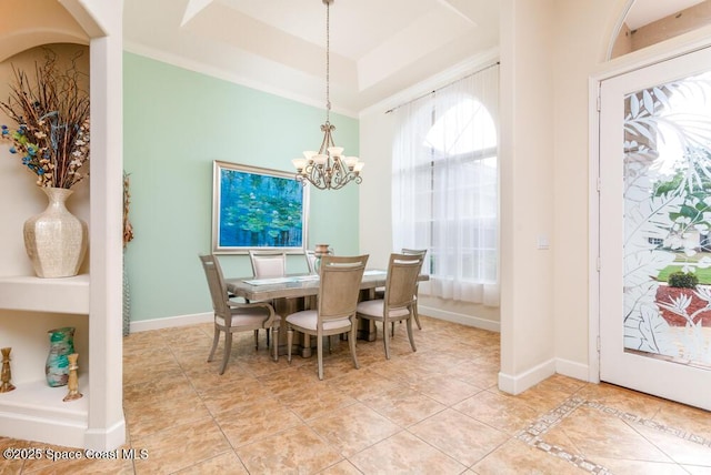 dining area with light tile patterned floors, a raised ceiling, and a chandelier