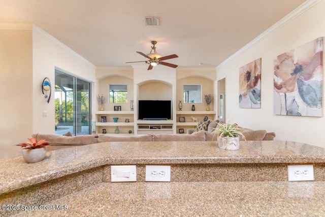 unfurnished living room with ceiling fan, ornamental molding, and built in features