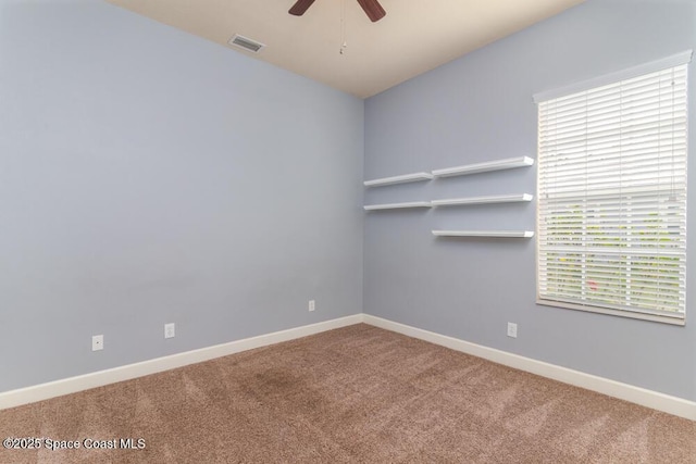 unfurnished room featuring ceiling fan and carpet flooring