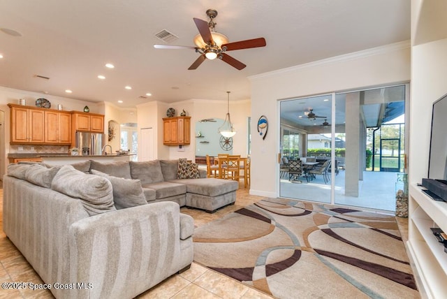 living room featuring ceiling fan, light tile patterned floors, and crown molding