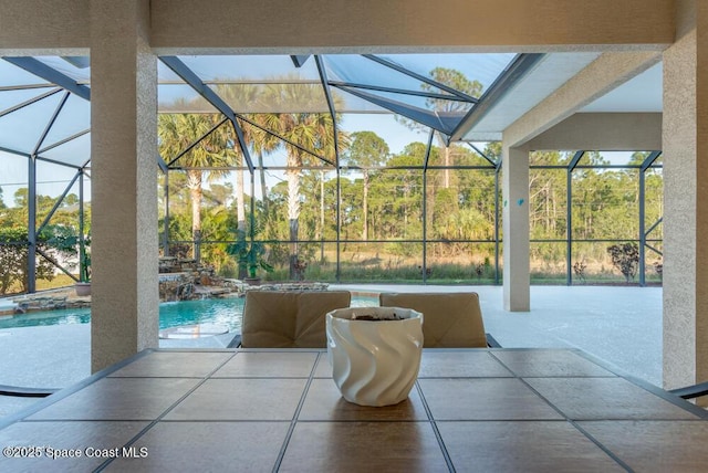 view of patio / terrace with glass enclosure and pool water feature