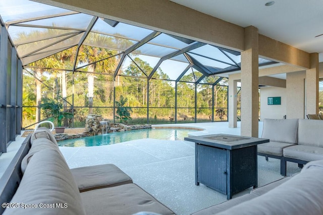 view of swimming pool featuring pool water feature, a patio area, outdoor lounge area, and glass enclosure