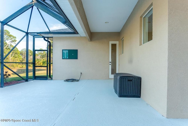 view of patio featuring a lanai