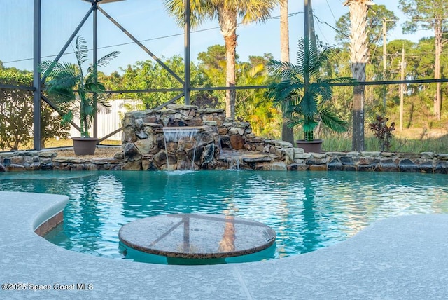 view of swimming pool with glass enclosure