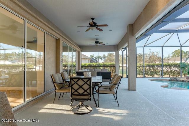 sunroom with a swimming pool and ceiling fan