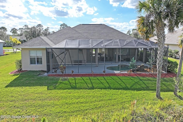 rear view of house featuring glass enclosure, a patio area, and a lawn