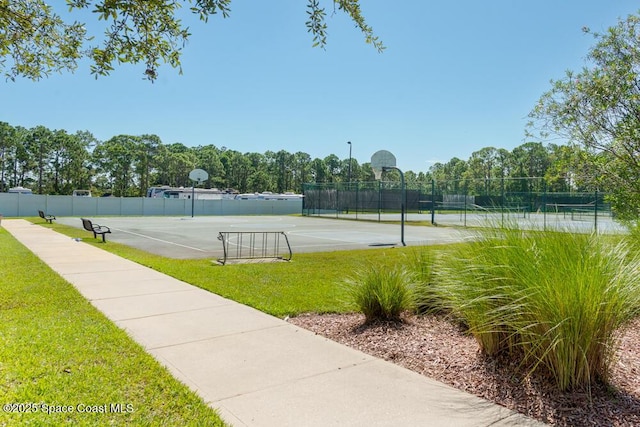 view of tennis court with basketball court and a lawn