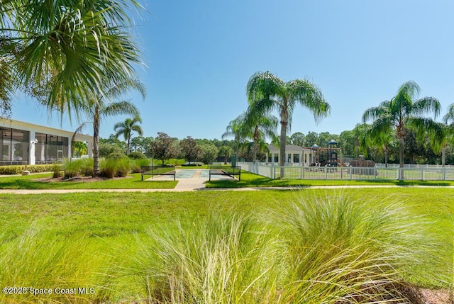 surrounding community with a yard and a swimming pool