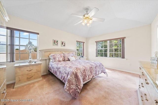 bedroom featuring light colored carpet, ceiling fan, and vaulted ceiling