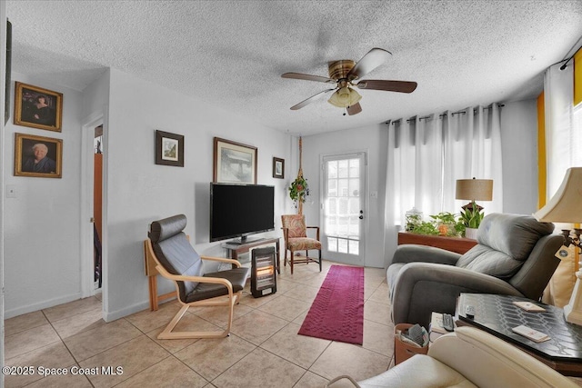 tiled living room featuring ceiling fan and a textured ceiling