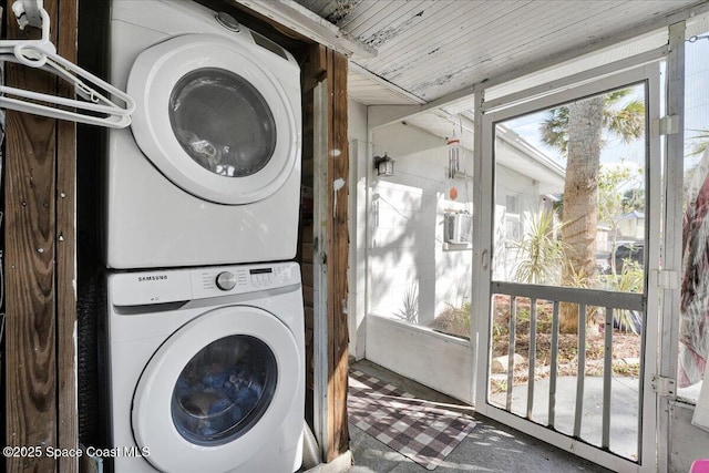 laundry room featuring stacked washer / drying machine