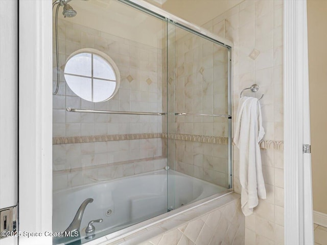 bathroom with bath / shower combo with glass door