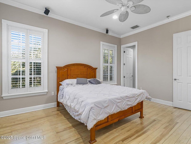 bedroom with ceiling fan, crown molding, and light hardwood / wood-style flooring