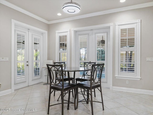 tiled dining space with crown molding and french doors