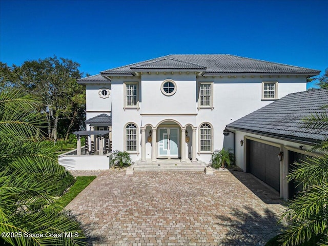 view of front of property featuring french doors and a garage