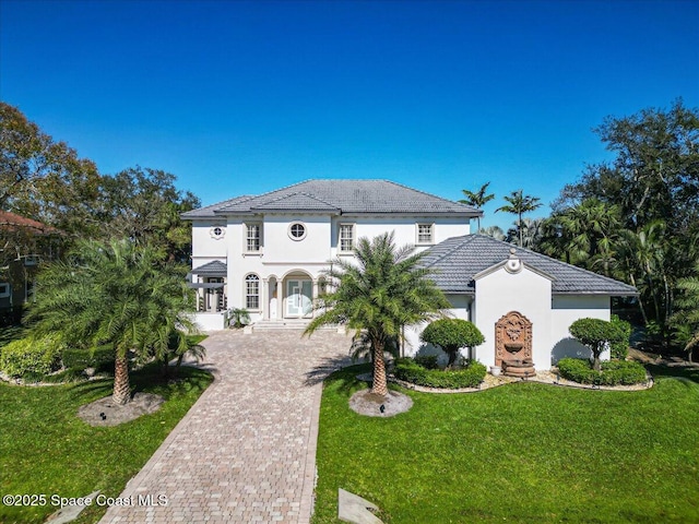 mediterranean / spanish-style home featuring a front yard