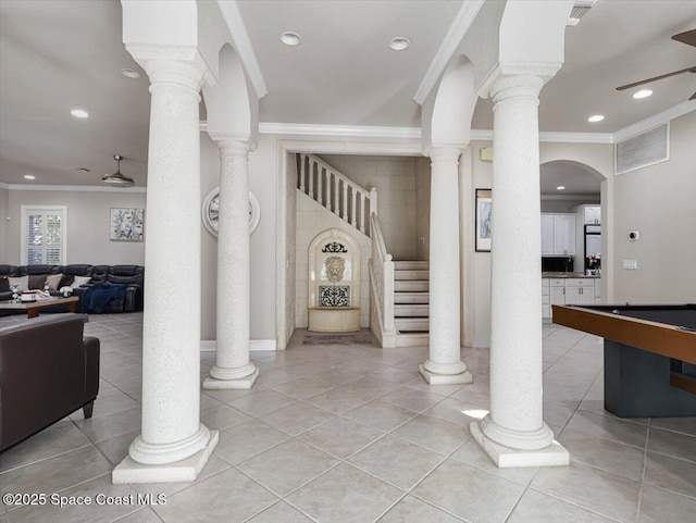 foyer entrance with light tile patterned floors, crown molding, and billiards