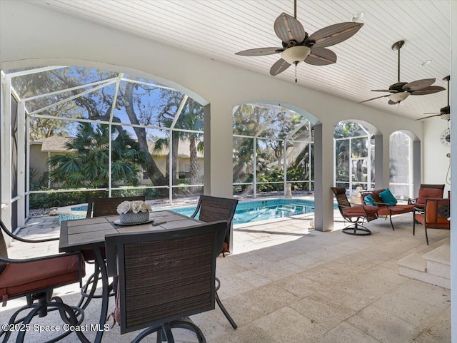 view of patio / terrace with ceiling fan and a lanai