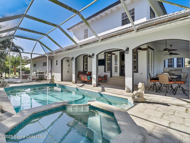 view of swimming pool with ceiling fan, a lanai, and a patio