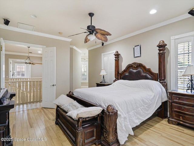 bedroom featuring light hardwood / wood-style floors, ceiling fan, and crown molding