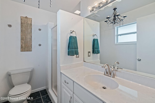 bathroom featuring toilet, an inviting chandelier, tile patterned floors, a shower with shower door, and vanity