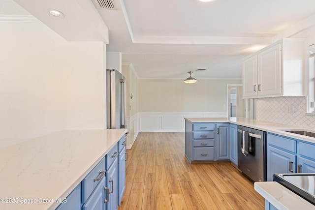 kitchen with dishwasher, blue cabinetry, light wood-style flooring, and white cabinets