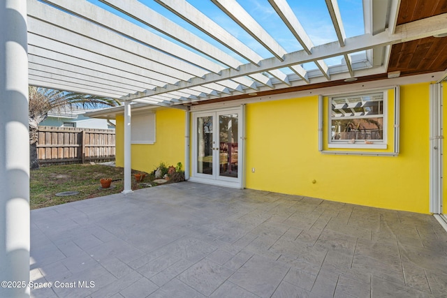 view of patio / terrace with french doors, fence, and a pergola